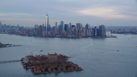 The Lower Manhattan skyline at sunset, New York City, seen from Ellis Island Aerial Stock Photos | AX121_014.0000000F