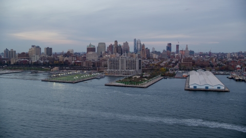 AX121_020.0000174F - Aerial stock photo of Piers 5 and 6 and Brooklyn skyline at sunset in New York City