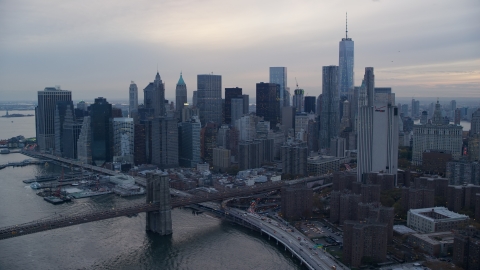 AX121_030.0000206F - Aerial stock photo of Lower Manhattan and the Brooklyn Bridge at sunset in New York City