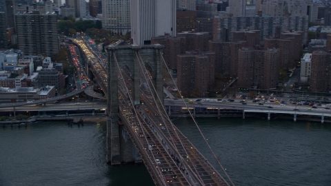 AX121_040.0000039F - Aerial stock photo of Downtown side of the Brooklyn Bridge at sunset in New York City