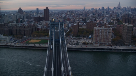 AX121_041.0000083F - Aerial stock photo of Light traffic on the Manhattan Bridge at sunset in New York City