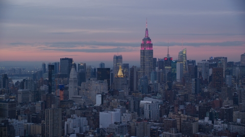 AX121_077.0000073F - Aerial stock photo of Empire State Building and Midtown skyscrapers at sunset in Midtown, New York City