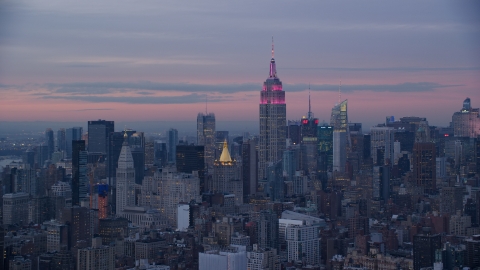 AX121_077.0000233F - Aerial stock photo of Empire State Building at Midtown high-rises at sunset in Midtown, New York City