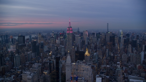 AX121_081.0000000F - Aerial stock photo of The Empire State Building and Midtown Manhattan skyscrapers at sunset in New York City