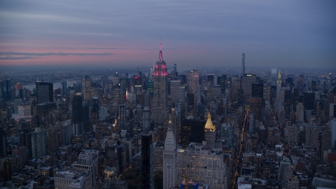 AX121_081.0000054F - Aerial stock photo of The Empire State Building and Midtown high-rises at sunset in New York City