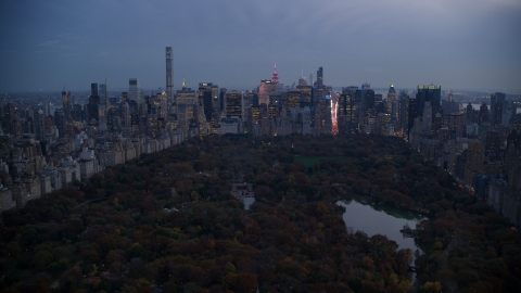 Midtown skyscrapers and The Lake in Central Park at sunset, New York City Aerial Stock Photos | AX121_098.0000102F