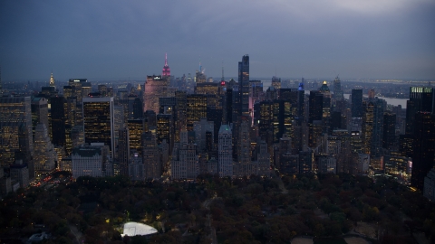 AX121_100.0000241F - Aerial stock photo of Midtown skyscrapers by Central Park at sunset in New York City