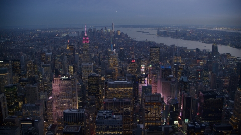 Lights of Times Square and Midtown skyscrapers, Lower Manhattan towers in distance at sunset, New York City Aerial Stock Photos | AX121_103.0000114F