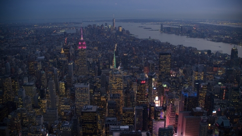 AX121_104.0000231F - Aerial stock photo of Lower Manhattan seen from Midtown near Times Square at sunset in New York City