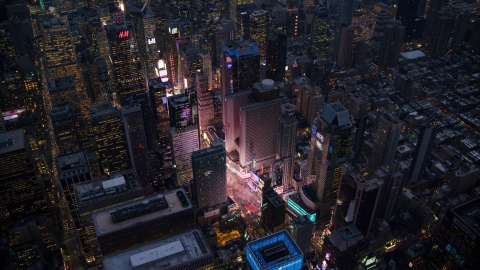 AX121_105.0000077F - Aerial stock photo of Bright lights of Times Square at sunset in Midtown Manhattan, New York City