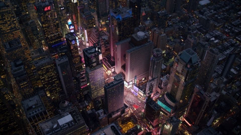 AX121_105.0000243F - Aerial stock photo of The bright lights and video screens of Times Square at sunset in Midtown, New York City