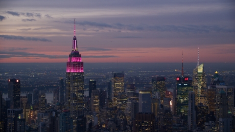 AX121_113.0000150F - Aerial stock photo of Empire State Building and Midtown skyscrapers at sunset in New York City