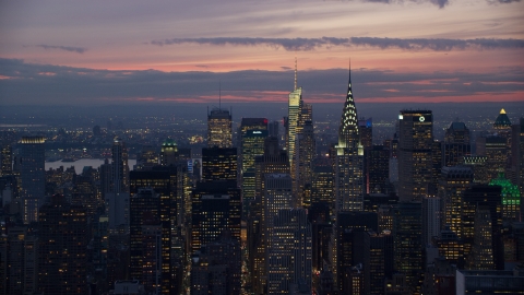 AX121_116.0000116F - Aerial stock photo of The Chrysler Building and Midtown Manhattan skyscrapers at sunset in New York City