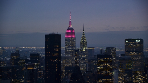 AX121_119.0000221F - Aerial stock photo of The Empire State and Chrysler Buildings at sunset in Midtown, New York City