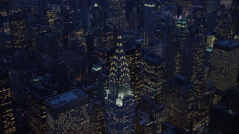 AX121_125.0000243F - Aerial stock photo of A view of the top of the Chrysler Building at sunset in the Midtown area of New York City