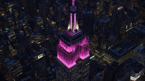 Top levels of the Empire State Building at sunset in Midtown, New York City Aerial Stock Photos | AX121_128.0000131F