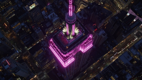 AX121_128.0000284F - Aerial stock photo of Bird's eye of the top of the Empire State Building at sunset in Midtown, New York City