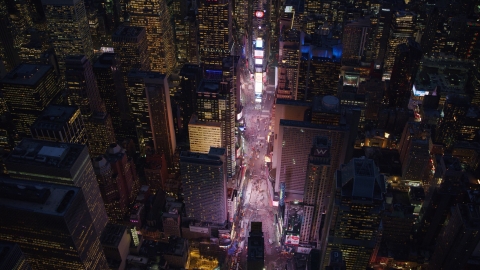 AX121_135.0000081F - Aerial stock photo of The bright lights of Times Square at night in Midtown, New York City