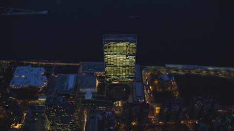 AX121_139.0000135F - Aerial stock photo of The United Nations at night in Midtown, New York City