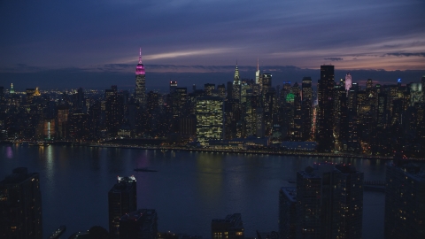 Midtown Manhattan across the East River at night in New York City Aerial Stock Photos | AX121_144.0000032F