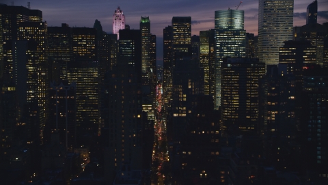 AX121_147.0000052F - Aerial stock photo of Midtown city canyon at night in New York City