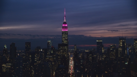 AX121_152.0000242F - Aerial stock photo of Empire State Building at night in Midtown Manhattan, NYC