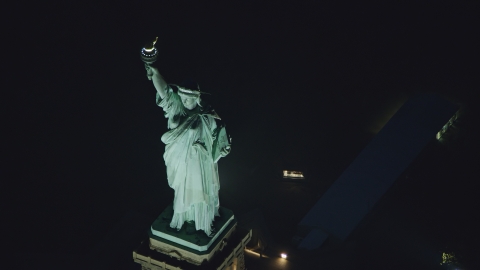 Statue of Liberty at nighttime in New York Aerial Stock Photos | AX121_168.0000211F