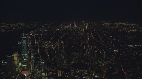 AX121_185.0000166F - Aerial stock photo of Midtown seen from near Freedom Tower at night in New York City