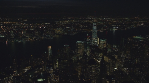 AX121_189.0000150F - Aerial stock photo of Freedom Tower and World Trade Center skyscrapers at night in New York City