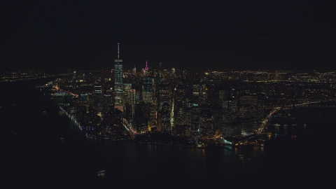 Lower Manhattan at night, seen from New York Harbor in New York City Aerial Stock Photos | AX121_194.0000066F