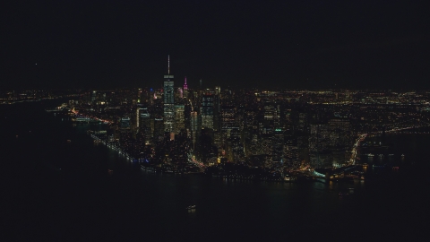 Lower Manhattan seen from New York Harbor at night in New York City Aerial Stock Photos | AX121_194.0000179F