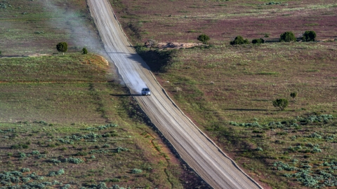 AX138_223.0000000 - Aerial stock photo of A silver SUV on Hatch Point Road in Moab, Utah