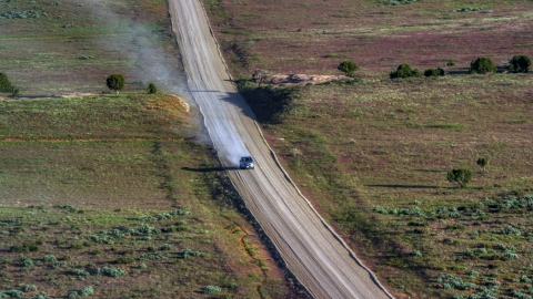 AX138_223.0000014 - Aerial stock photo of A view of a silver SUV on Hatch Point Road, Moab, Utah