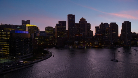 AX141_023.0000301 - Aerial stock photo of The skyline seen from over the harbor, Downtown Boston, Massachusetts, twilight