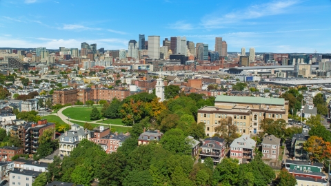 AX142_226.0000344 - Aerial stock photo of Dorchester Heights Monument in South Boston, and Downtown Boston skyline, Massachusetts