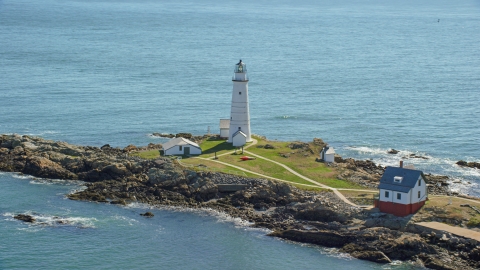 AX142_261.0000262 - Aerial stock photo of The Boston Light overlooking the water on Little Brewster Island, Boston Harbor, Massachusetts