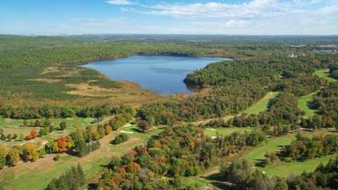 AX143_001.0000010 - Aerial stock photo of Ponkapoag Pond in autumn, Canton, Massachusetts