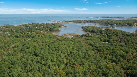 AX143_024.0000262 - Aerial stock photo of Forest and a small coastal community in autumn, Cohasset, Massachusetts