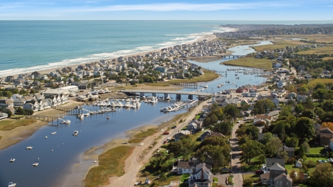 A small community between the coast and a small bridge spanning Broad Creek, Humarock, Massachusetts Aerial Stock Photos | AX143_051.0000000