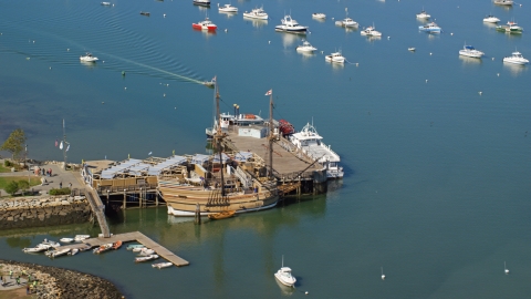 AX143_089.0000203 - Aerial stock photo of The Mayflower II and Mayflower II Museum, Plymouth, Massachusetts