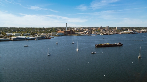 AX144_192.0000000 - Aerial stock photo of A coastal community, and a factory with smoke stack, New Bedford, Massachusetts