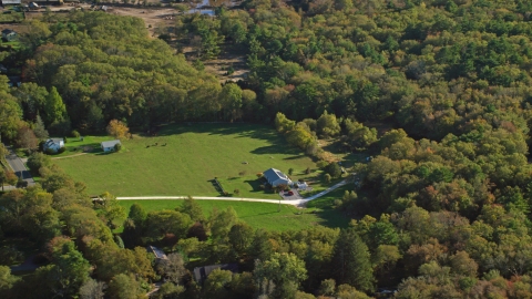 AX144_214.0000062 - Aerial stock photo of Rural homes and green lawns surrounded by trees, Dartmouth, Massachusetts