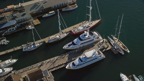 AX144_238.0000119 - Aerial stock photo of Two yachts docked near sailboats at piers in Newport, Rhode Island