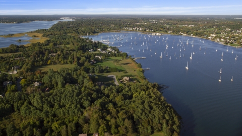 AX145_013.0000000 - Aerial stock photo of Waterfront mansions near sailboats in Bristol Harbor, Bristol, Rhode Island