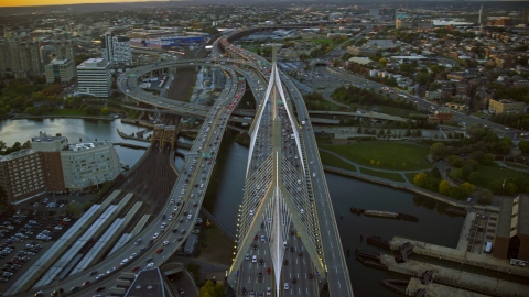 AX146_088.0000113F - Aerial stock photo of Traffic on the Zakim Bridge, Boston, Massachusetts, sunset