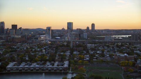 AX146_096.0000095F - Aerial stock photo of Bunker Hill Monument and waterfront residences, Charlestown, Massachusetts, sunset