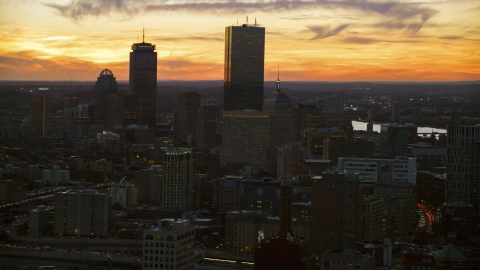 AX146_137.0000054F - Aerial stock photo of Towering skyscrapers and city buildings at twilight in Downtown Boston, Massachusetts