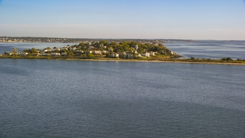 AX147_016.0000000 - Aerial stock photo of A coastal community nestled by trees on a peninsula in the bay, Nahant, Massachusetts