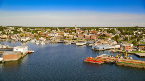 AX147_087.0000376 - Aerial stock photo of Coastal town, small warehouse buildings on the shore, Gloucester, Massachusetts