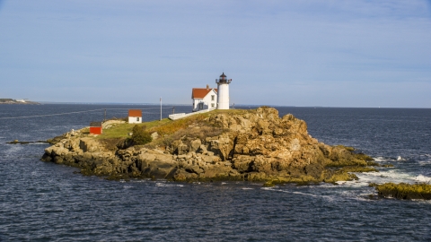 AX147_237.0000000 - Aerial stock photo of Cape Neddick Light overlooking the ocean, York, Maine